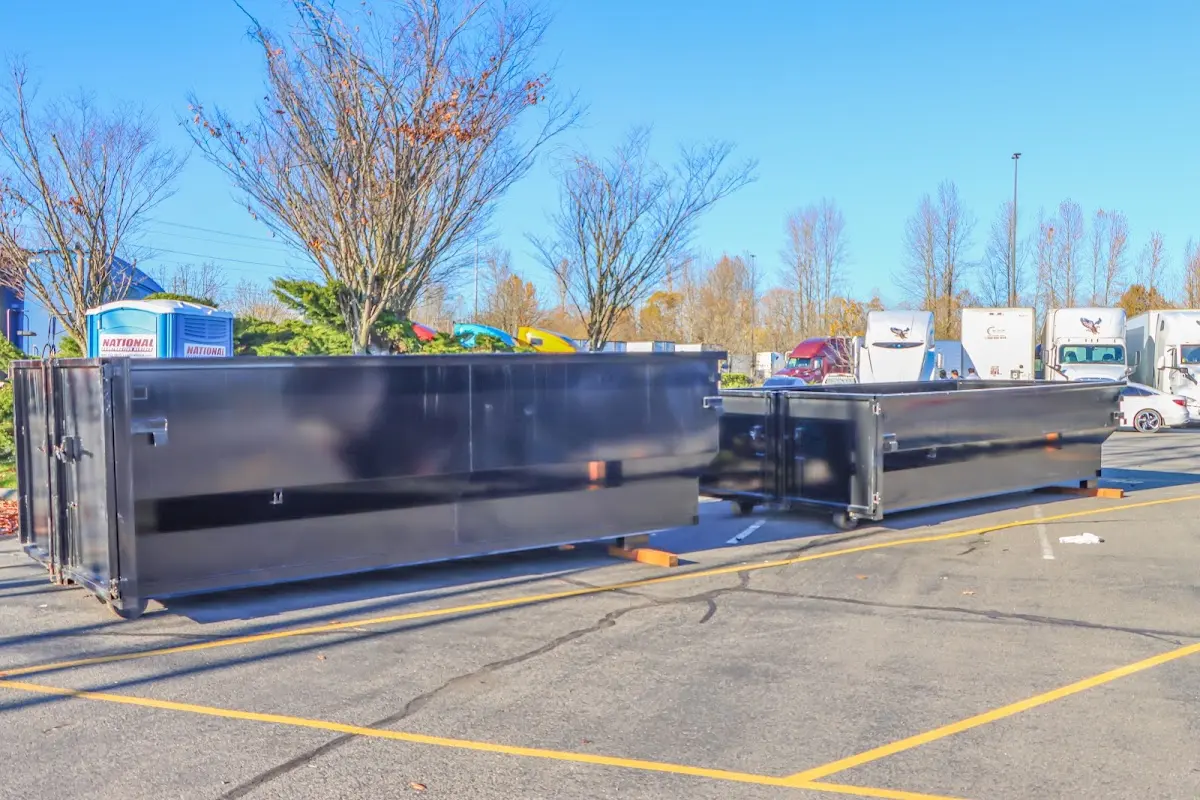 Professional dumpster rental service with roll-off container on residential driveway in Antwerp